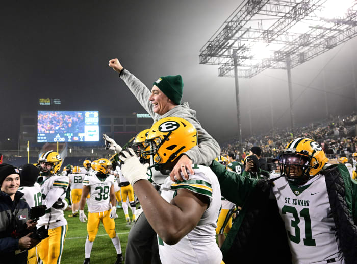 St. Edward head coach Tom Lombardo is carried off by his players after winning the Division I state title on December 1, 2023. Photo credit: Jeff Harwell, SBLive Sports